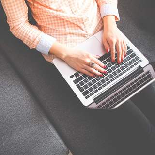 person sitting watching a laptop computer